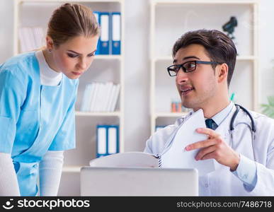 The male and female doctor having discussion in hospital. Male and female doctor having discussion in hospital