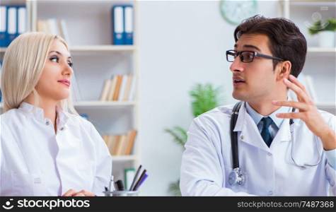 The male and female doctor having discussion in hospital. Male and female doctor having discussion in hospital
