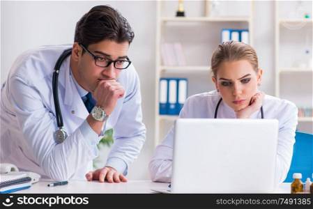 The male and female doctor having discussion in hospital. Male and female doctor having discussion in hospital
