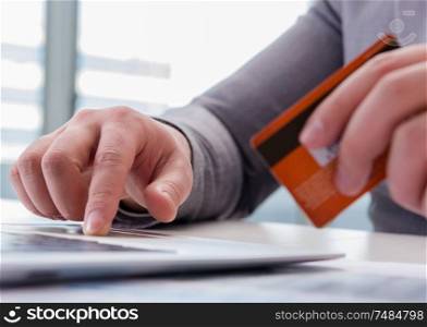 The male businessman doing online shopping with credit card. Male businessman doing online shopping with credit card