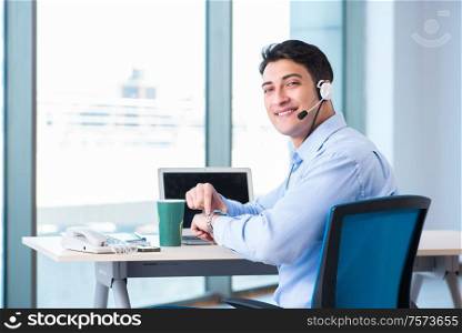 The male call-center operator in business concept. Male call-center operator in business concept