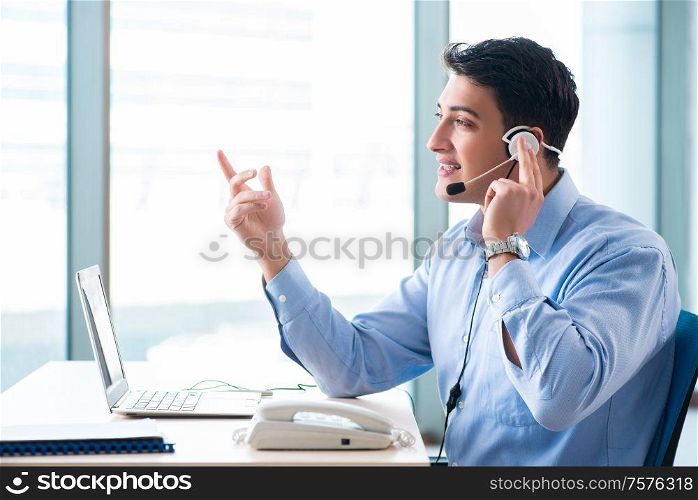 The male call-center operator in business concept. Male call-center operator in business concept