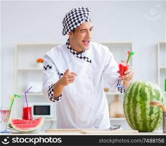 The male cook with watermelon in kitchen. Male cook with watermelon in kitchen