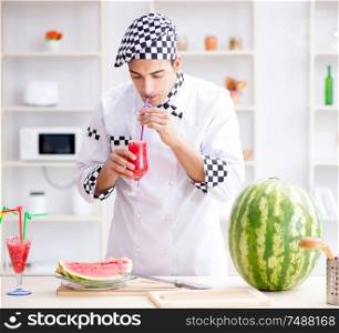 The male cook with watermelon in kitchen. Male cook with watermelon in kitchen