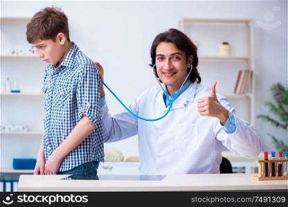 The male doctor examining boy by stethoscope. Male doctor examining boy by stethoscope