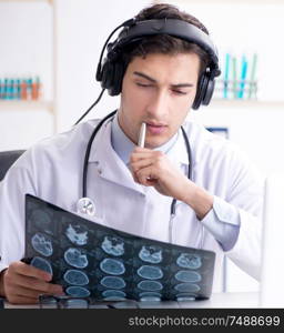 The male doctor listening to patient during telemedicine session. Male doctor listening to patient during telemedicine session