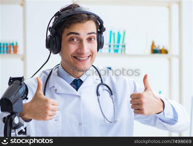 The male doctor listening to patient during telemedicine session. Male doctor listening to patient during telemedicine session