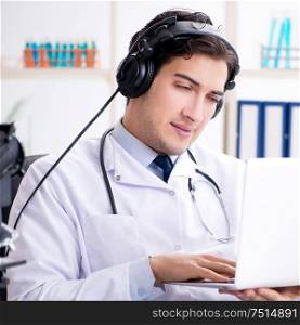 The male doctor listening to patient during telemedicine session. Male doctor listening to patient during telemedicine session