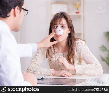 The male doctor talking to patient with nose operation surgery. Male doctor talking to patient with nose operation surgery