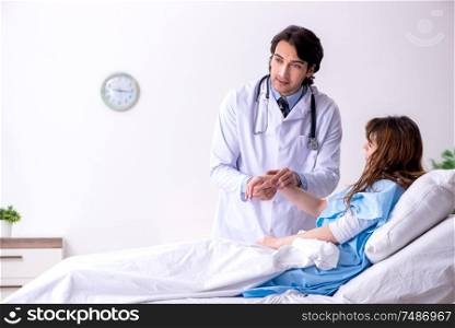 The male doctor visiting female patient in ward. Male doctor visiting female patient in ward