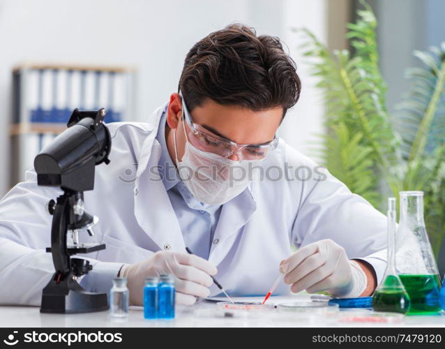 The male doctor working in the lab on virus vaccine. Male doctor working in the lab on virus vaccine