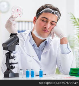 The male doctor working in the lab on virus vaccine. Male doctor working in the lab on virus vaccine