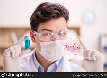 The male doctor working in the lab on virus vaccine. Male doctor working in the lab on virus vaccine