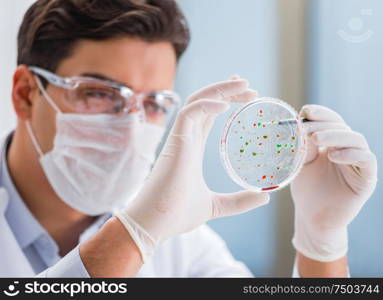 The male doctor working in the lab on virus vaccine. Male doctor working in the lab on virus vaccine