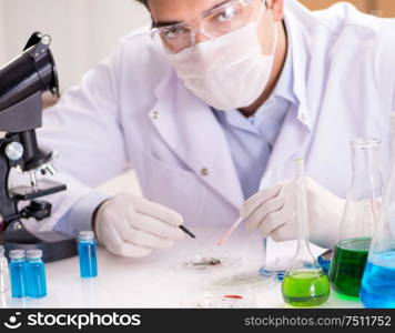 The male doctor working in the lab on virus vaccine. Male doctor working in the lab on virus vaccine