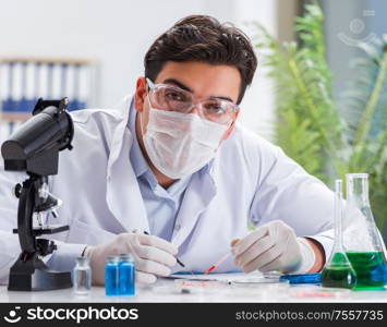 The male doctor working in the lab on virus vaccine. Male doctor working in the lab on virus vaccine