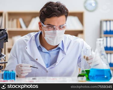 The male doctor working in the lab on virus vaccine. Male doctor working in the lab on virus vaccine