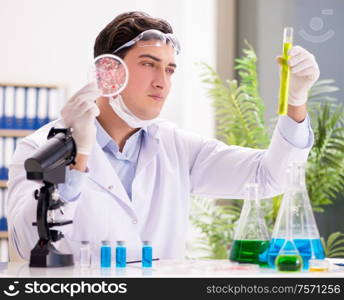 The male doctor working in the lab on virus vaccine. Male doctor working in the lab on virus vaccine