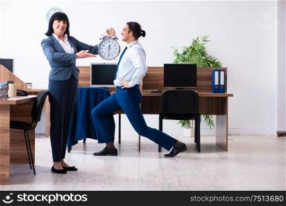 The male employee doing sport exercises in the office. Male employee doing sport exercises in the office