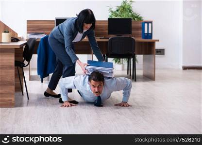 The male employee doing sport exercises in the office. Male employee doing sport exercises in the office