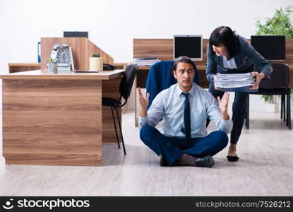 The male employee doing yoga exercises in the office. Male employee doing yoga exercises in the office