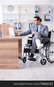 The male employee in wheel-chair in the office. Male employee in wheel-chair in the office