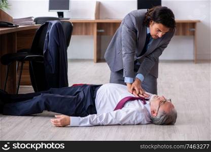 The male employee suffering from heart attack in the office . Male employee suffering from heart attack in the office 