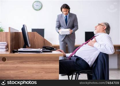 The male employee suffering from heart attack in the office . Male employee suffering from heart attack in the office