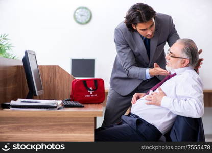 The male employee suffering from heart attack in the office. Male employee suffering from heart attack in the office