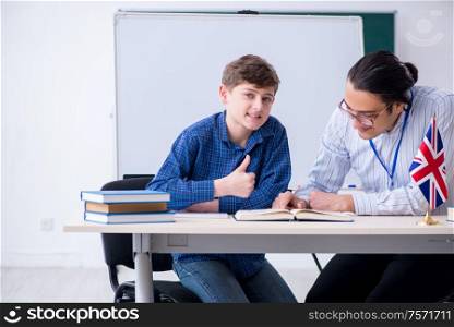 The male english teacher and boy in the classroom. Male english teacher and boy in the classroom
