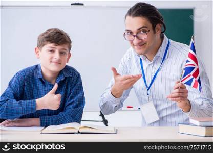 The male english teacher and boy in the classroom. Male english teacher and boy in the classroom