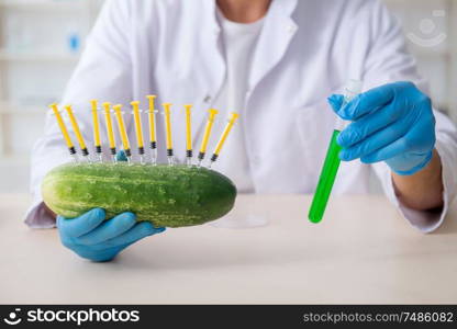 The male nutrition expert testing vegetables in lab. Male nutrition expert testing vegetables in lab