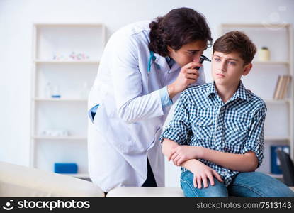 The male otolaryngologist examining boy&rsquo;s ear. Male otolaryngologist examining boy&rsquo;s ear