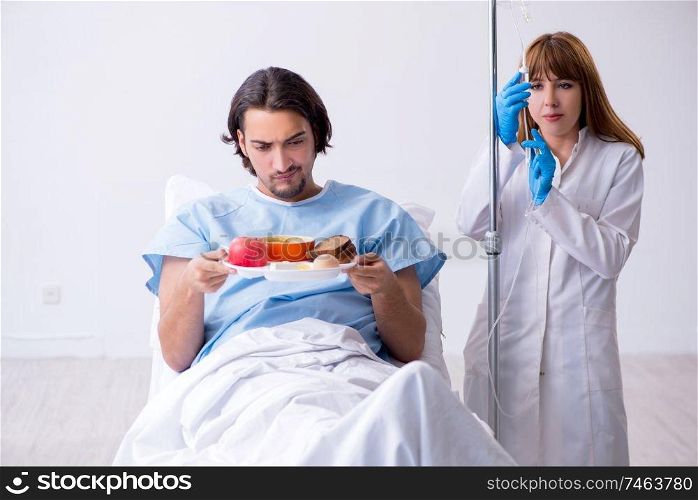 The male patient eating food in the hospital . Male patient eating food in the hospital 