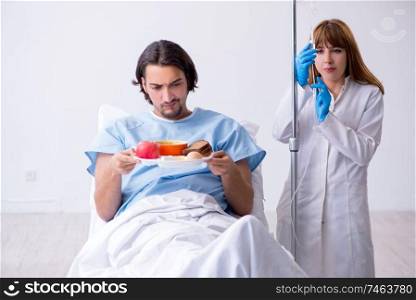 The male patient eating food in the hospital . Male patient eating food in the hospital 