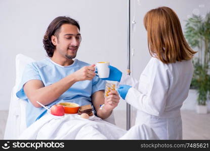 The male patient eating food in the hospital . Male patient eating food in the hospital