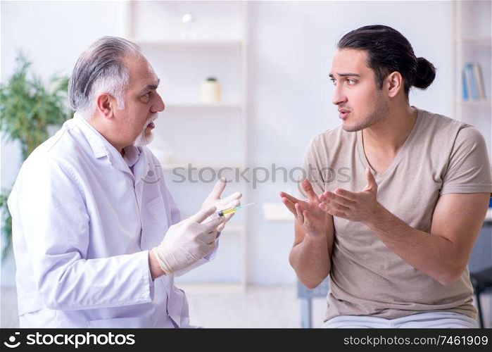 The male patient visitng doctor for shot inoculation . Male patient visitng doctor for shot inoculation 