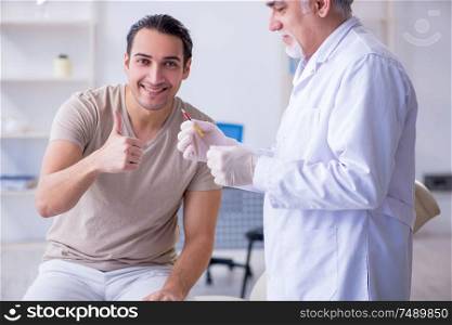 The male patient visitng doctor for shot inoculation . Male patient visitng doctor for shot inoculation