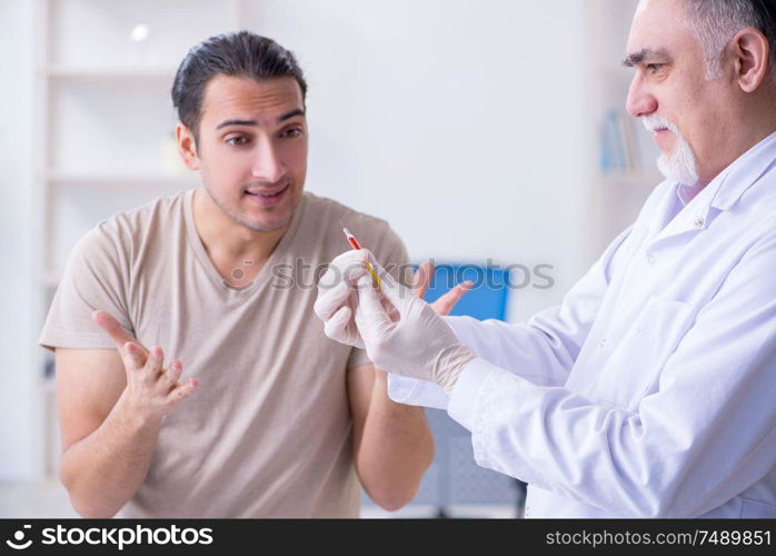 The male patient visitng doctor for shot inoculation. Male patient visitng doctor for shot inoculation