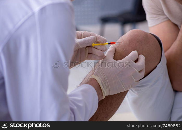 The male patient visitng doctor for shot inoculation. Male patient visitng doctor for shot inoculation