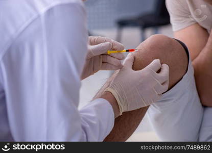 The male patient visitng doctor for shot inoculation. Male patient visitng doctor for shot inoculation