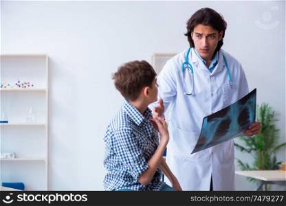 The male radiologist looking at boy&rsquo;s images . Male radiologist looking at boy&rsquo;s images