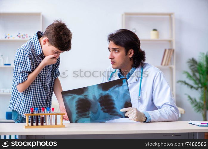 The male radiologist looking at boy&rsquo;s images . Male radiologist looking at boy&rsquo;s images