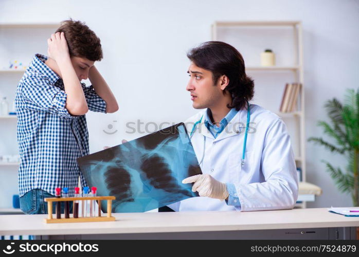 The male radiologist looking at boy&rsquo;s images. Male radiologist looking at boy&rsquo;s images