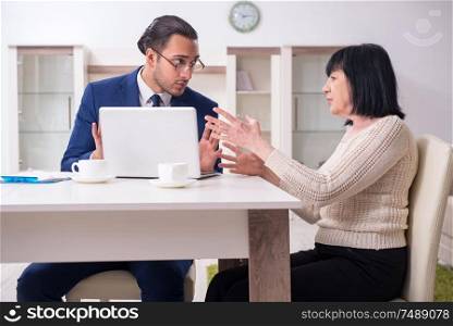 The male real estate agent and female client in the apartment . Male real estate agent and female client in the apartment