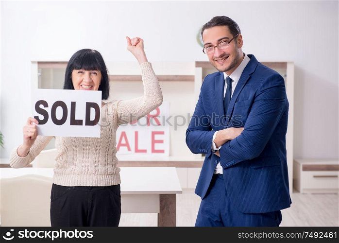 The male real estate agent and female client in the apartment. Male real estate agent and female client in the apartment