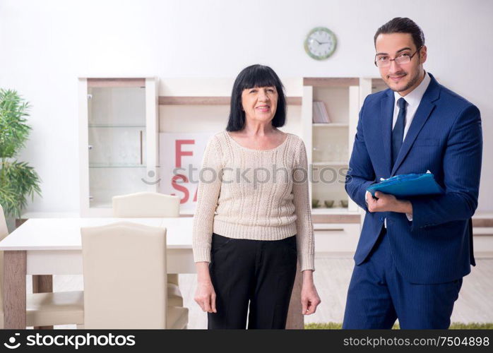 The male real estate agent and female client in the apartment. Male real estate agent and female client in the apartment