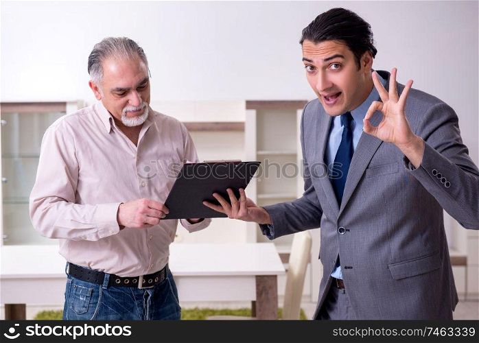 The male real estate agent and male client in the apartment . Male real estate agent and male client in the apartment 