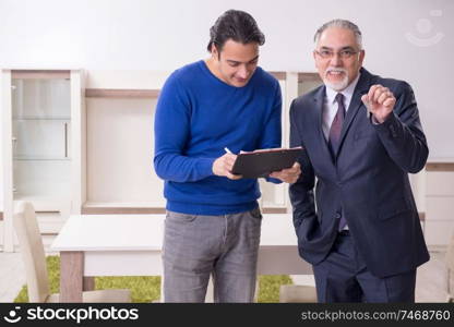 The male real estate agent and male client in the apartment . Male real estate agent and male client in the apartment 