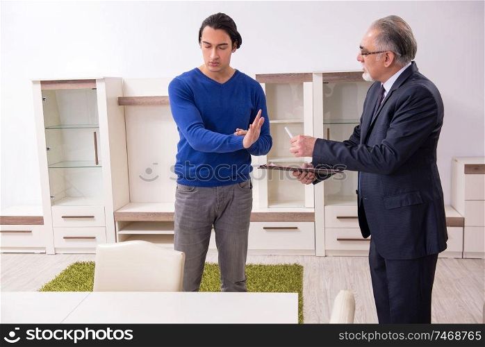 The male real estate agent and male client in the apartment . Male real estate agent and male client in the apartment 